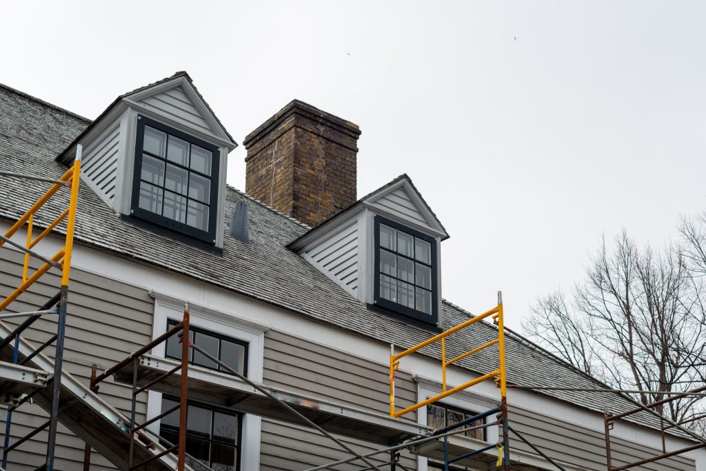 Black window frames and trim being installed.