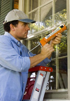 man installing siding and windows in joliet