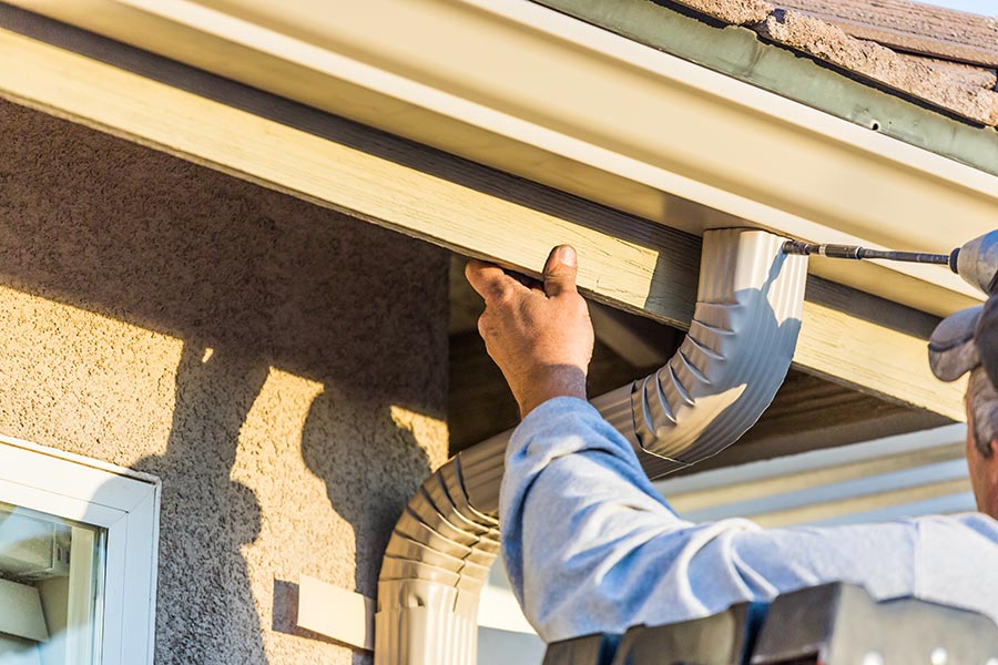 joliet gutter installers working to tighten gutters