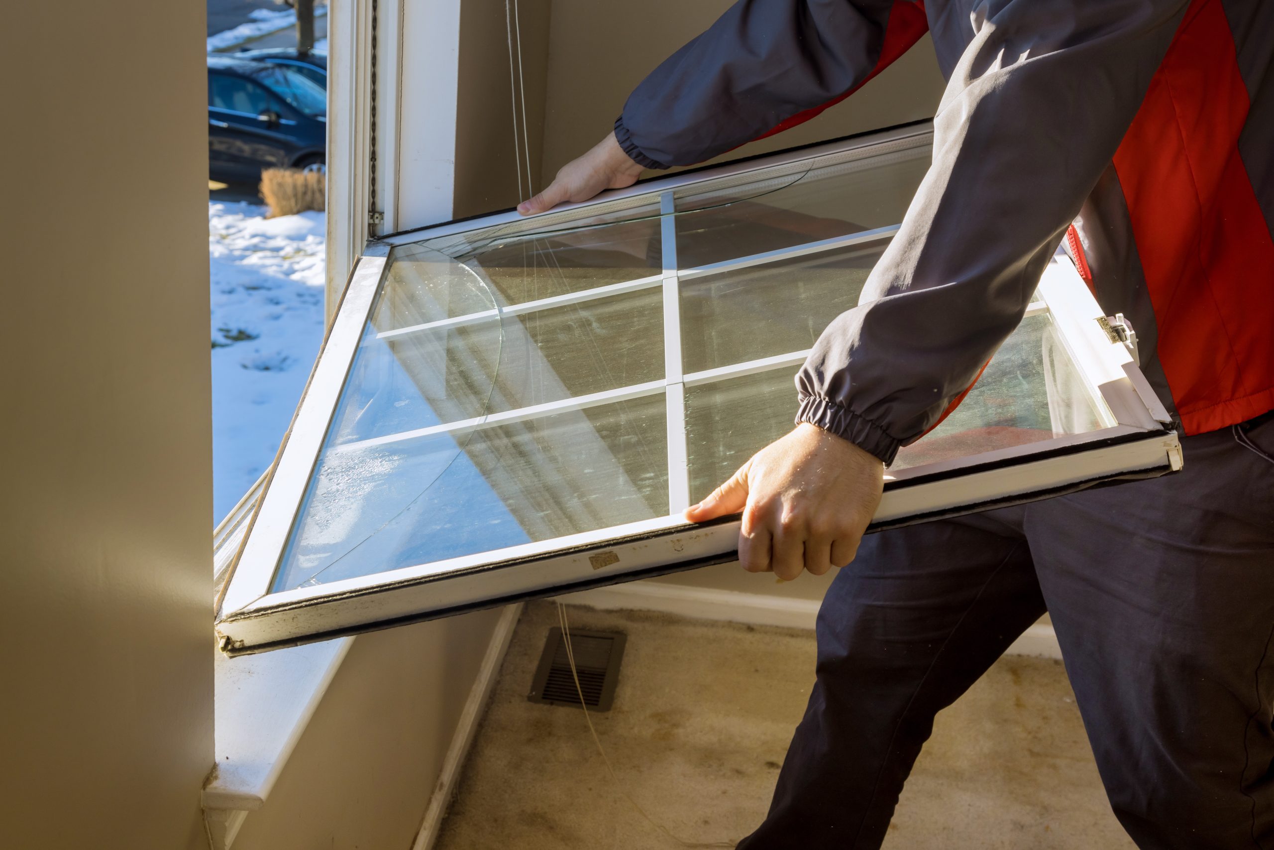 Man working to install energy-efficient windows for winter in Joliet