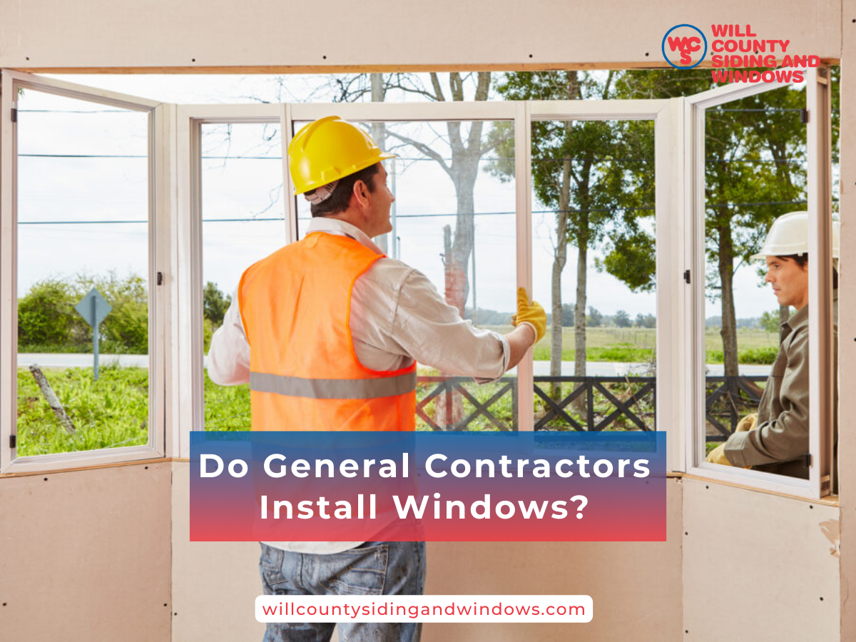 Two construction workers in safety gear installing a large window frame inside a house under construction.